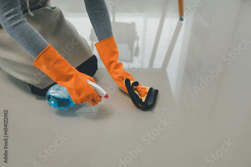 Clean the floor with a mop, Clean the floor in the living room, Clean the rooms inside the apartment for hygiene, Use a towel to wipe the floor clean,