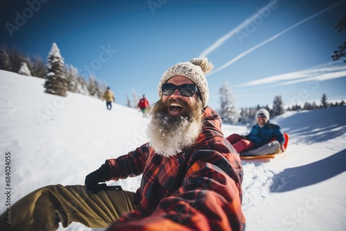 Older people friends riding on snow tubing from the hill with funny emotions photo