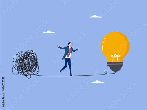 Simplify idea to find solution, thinking process or creativity to solve problem, discover easy way to understand concept, smart businessman walking away from mess chaos line to simple light bulb idea. photo
