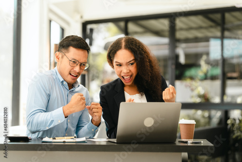 Wallpaper Mural Asian business man and African American woman engaging in business discussion, possibly about merger or joint venture. two companies become one, one of companies often survives while other disappears Torontodigital.ca