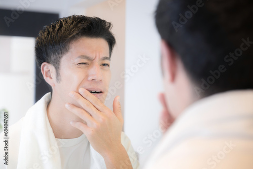 Men with toothache Men with toothache - may be a little painful and stinging - image of sensitivity and tooth decay photo