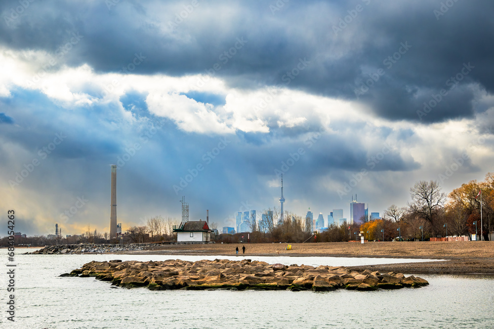 kew beach toronto on a fall afternoon with dramatic clouds and the downtown city skyline in the background room for text