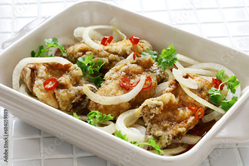 Oyster escabeche, battered and fried oysters marinated with vinegar sauce. photo