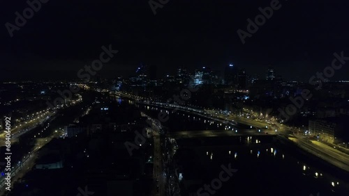 Ascending drone shot of Saint-Louis Island and Bridge of Sully at night in the Seine river, France photo