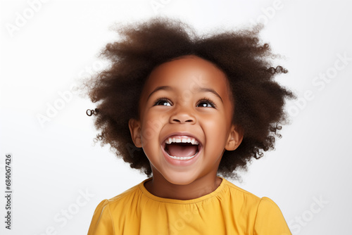 Brightly Smiling African American Little Boy's Portrait Against a White Background, Close-Up Shot Capturing the Vibrant Emotions and Joyful Laughter of the Child