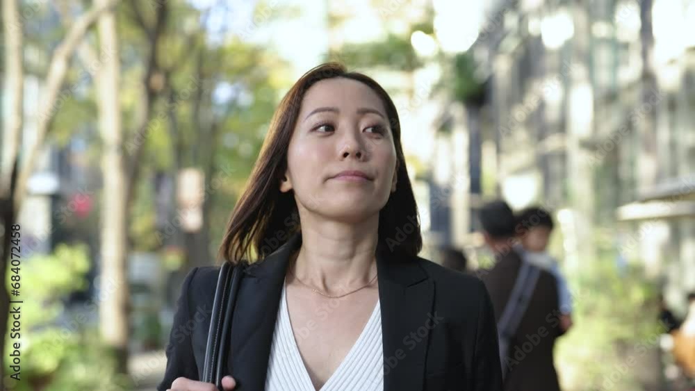 ビジネス街を歩くスーツ姿の女性 ビジネス街を歩くスーツ姿の女性