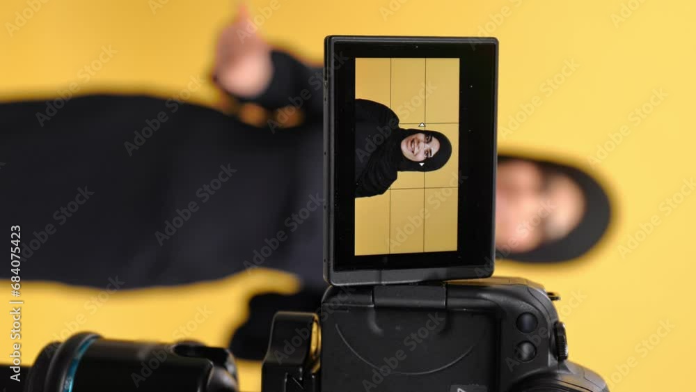 VERTICAL VIDEO POV camera display Turkish woman in black hijab record video isolated orange studio VERTICAL VIDEO POV camera display Turkish woman in black hijab record video isolated orange studio