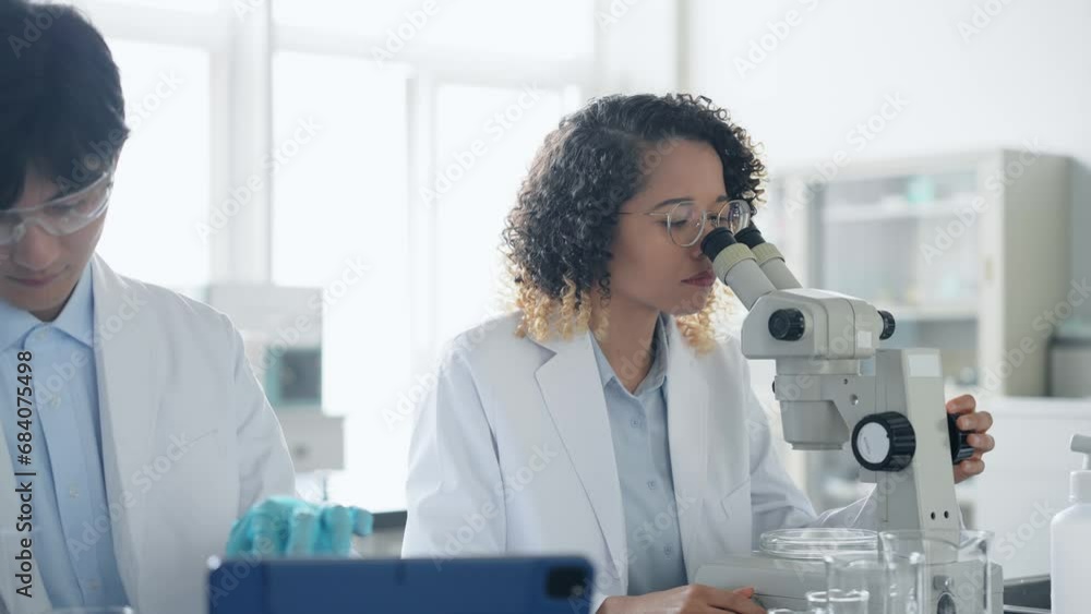Multinational researcher group experimenting in the lab. Research and Development. Multinational researcher group experimenting in the lab. Research and Development.