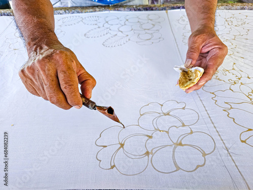 Making batik by drawing beautiful patterns by hand. photo