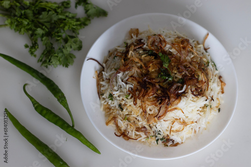 Deliciously fragrant Paneer Biryani, a vibrant Indian rice dish made with basmati rice, layered with aromatic spices, paneer cubes, herbs and caramelized onions photo