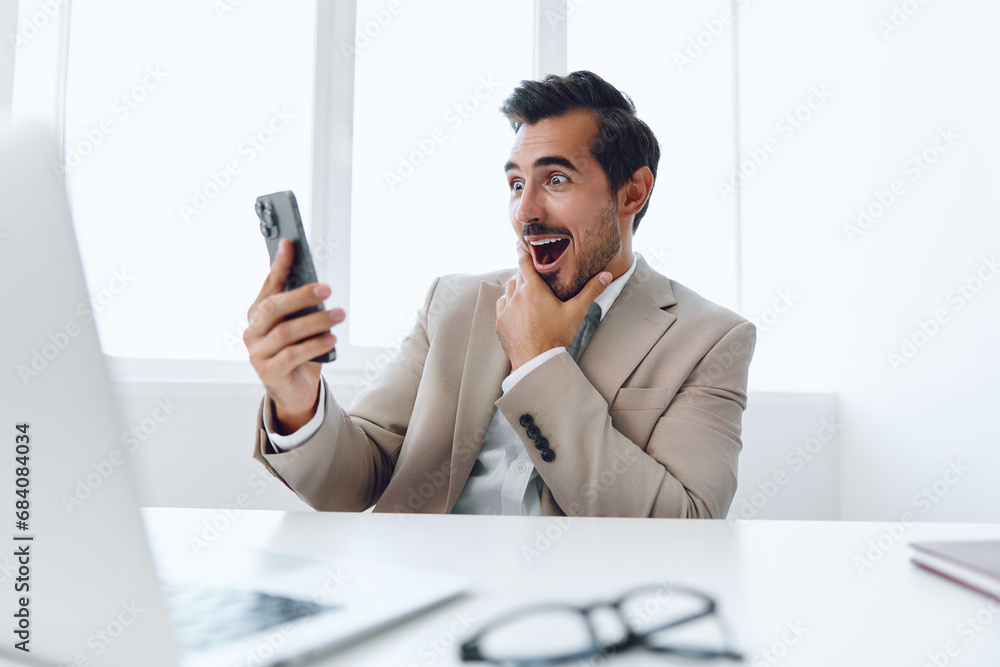 Man attractive happy smile caucasian winner laptop businessman phone computer office talk Man attractive happy smile caucasian winner laptop businessman phone computer office talk