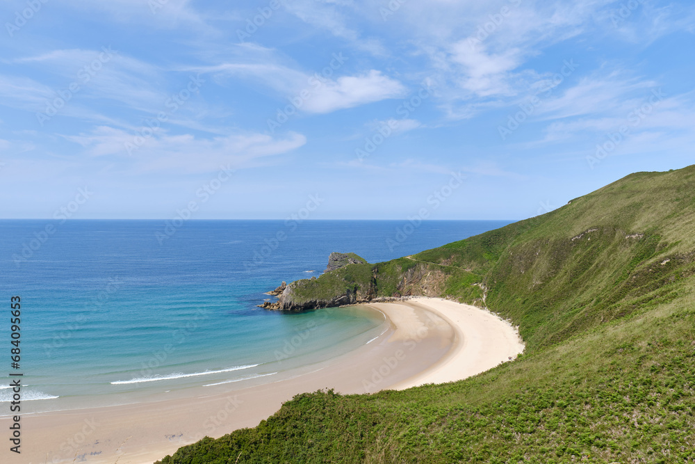 sandy beach surrounded by green mountains in a natural spot of cliffs in Asturias, Spain, torimbia beach
