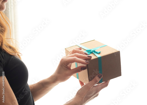 Close up shot of the woman holding rapped gift box. Holiday