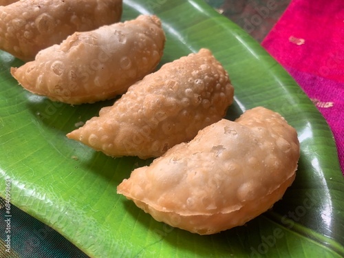 Gujiya or gujia or karanji - sweet dumplings. Indian snack made on diwali, holi and for celebrations called karanji in Maharashtra and Ghujia in central India