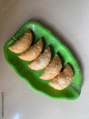 Gujiya or gujia or karanji - sweet dumplings. Indian snack made on diwali, holi and for celebrations called karanji in Maharashtra and Ghujia in central India photo