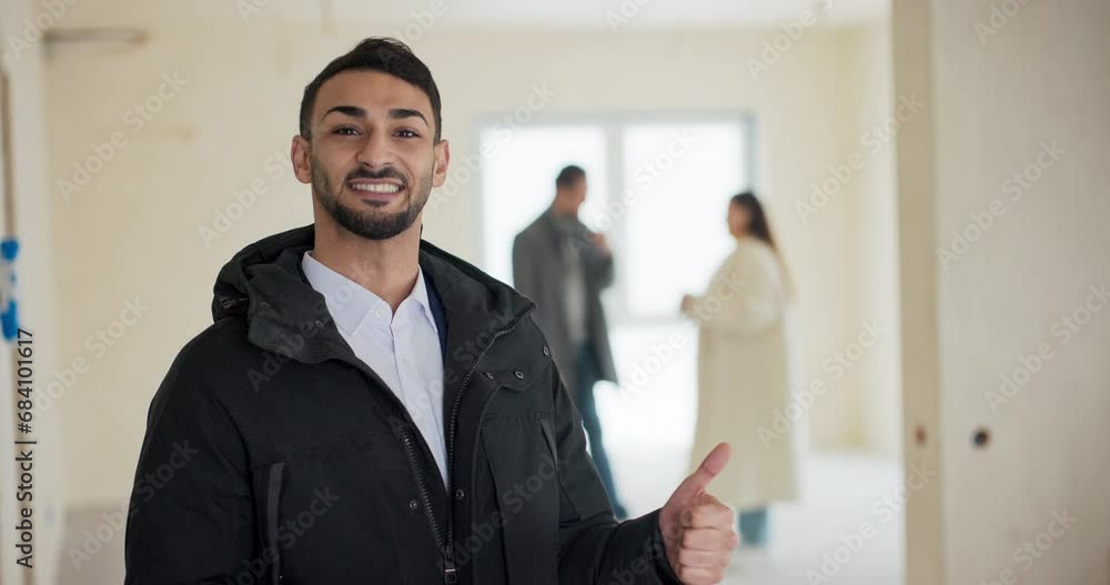 Male real estate developer sells house to young couple who are discussing purchase of an apartment in background. Real estate agent has convinced buyers to choose his business, proudly shows thumbs up Male real estate developer sells house to young couple who are discussing purchase of an apartment in background. Real estate agent has convinced buyers to choose his business, proudly shows thumbs up