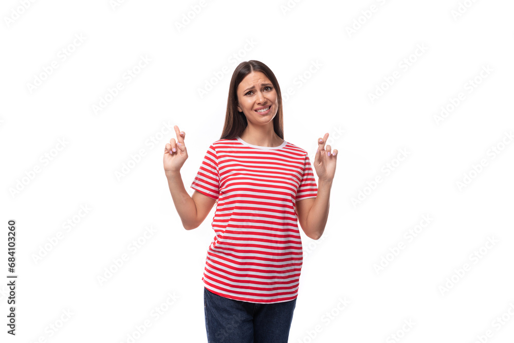 A 35 year old European lady in a red striped T-shirt crossed her fingers in hope A 35 year old European lady in a red striped T-shirt crossed her fingers in hope