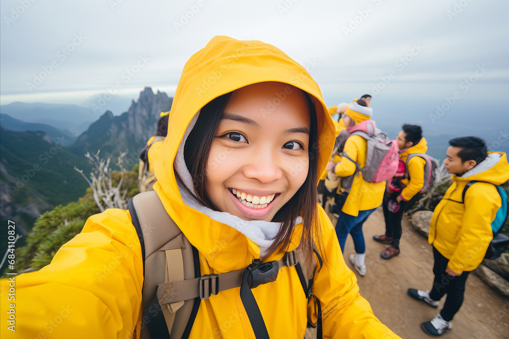 Happy smiling Asian girl tourist taking selfie portrait on mountain top Happy smiling Asian girl tourist taking selfie portrait on mountain top