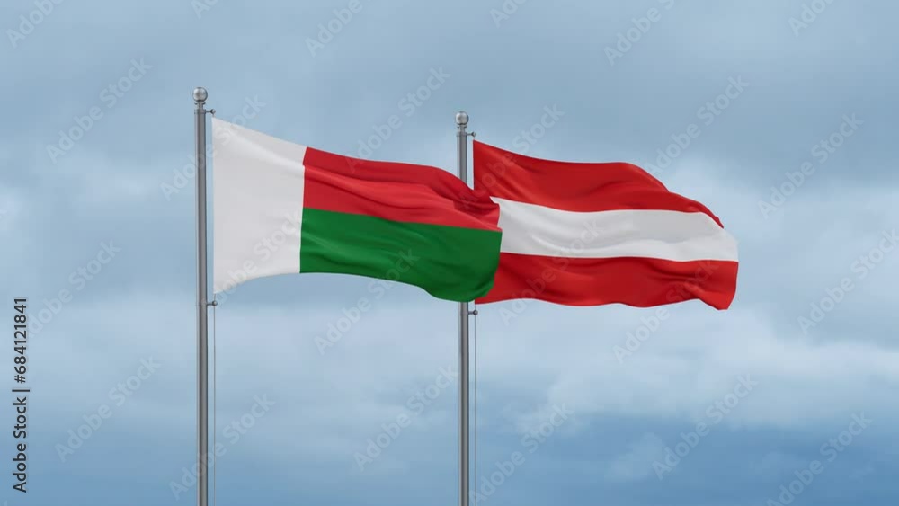 Austria flag and Madagascar flag waving together on cloudy sky, endless seamless loop, two country relations concept Austria flag and Madagascar flag waving together on cloudy sky, endless seamless loop, two country relations concept