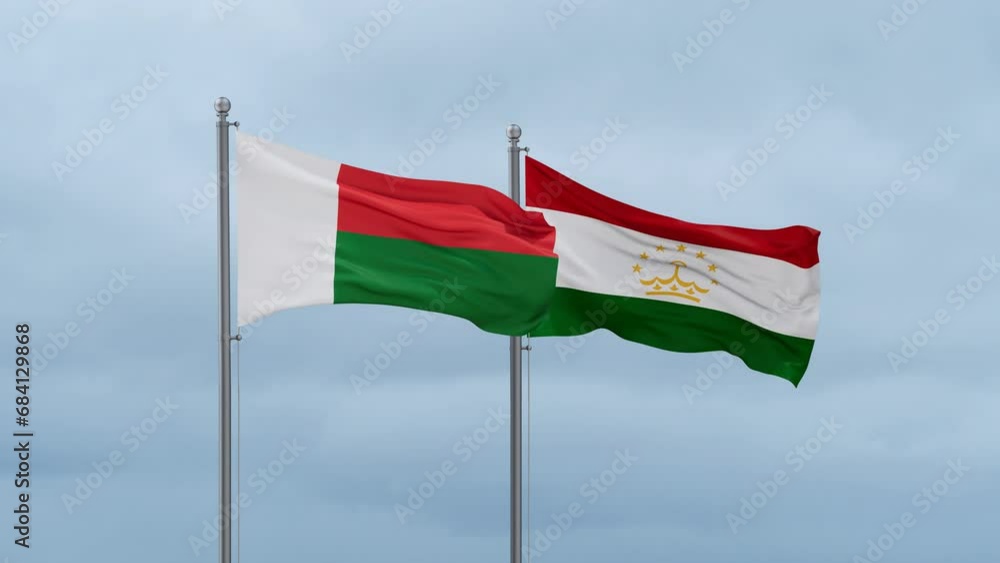 Tajikistan and Madagascar flag waving together on cloudy sky, endless seamless loop, two country cooperation concept Tajikistan and Madagascar flag waving together on cloudy sky, endless seamless loop, two country cooperation concept