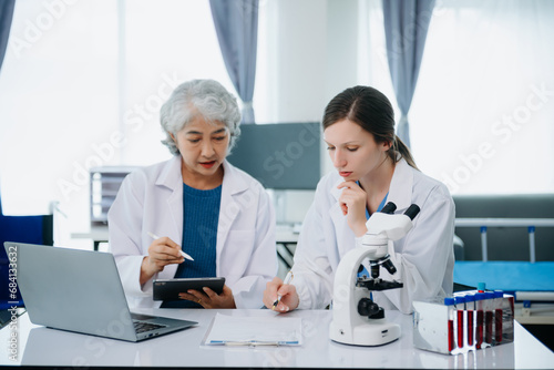 Medical team having a meeting with doctors. Young scientists conducting research investigations in a medical laboratory, a researcher.