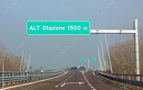 road sign in the motorway which means stop station at 1500 m because you have to pay the toll photo