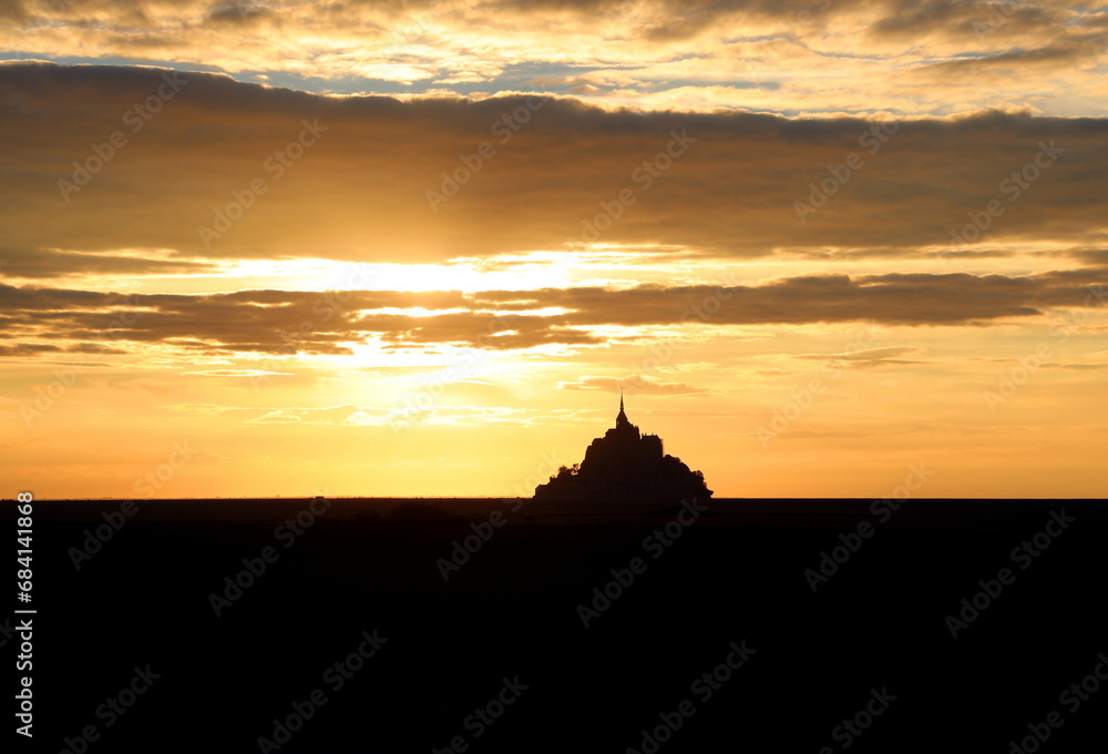 abbey of Mont saint-michel in Normandy in northern France at sunset with fiery sky