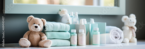 Baby care essentials: lotion powder diapers on nursery changing table  photo
