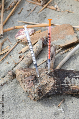 two used syringes abandoned near the beach