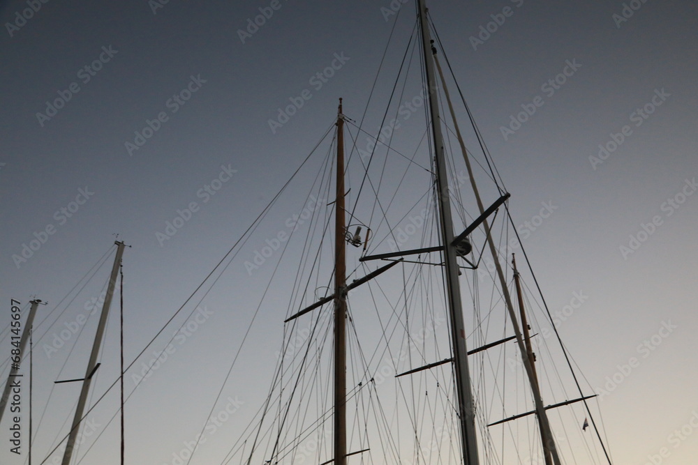 Sailboat mast on a evening sky