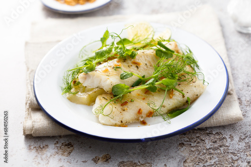 Baked white fish filet with green pea and lime