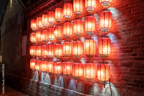 Red lanterns hung on the wall at night