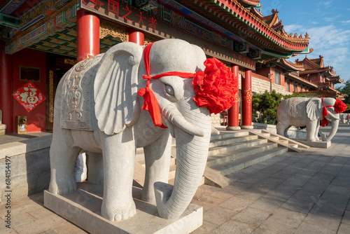 Wedding decoration, large red flowers on elephant sculptures © onlyyouqj