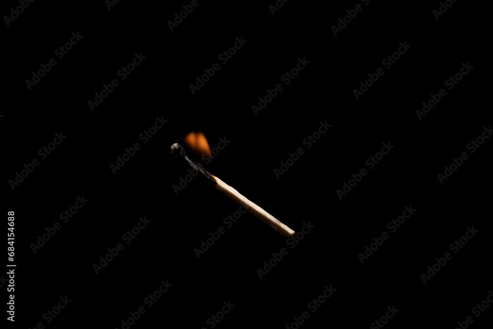 Lit falling match on a black background. Lit falling match on a black background.