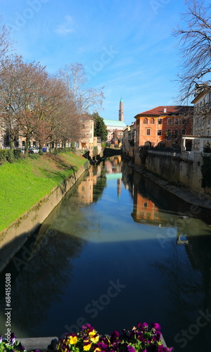 views of the historic center of Vicenza and the river called Retrone with the high Tower of the Palladian Basilica