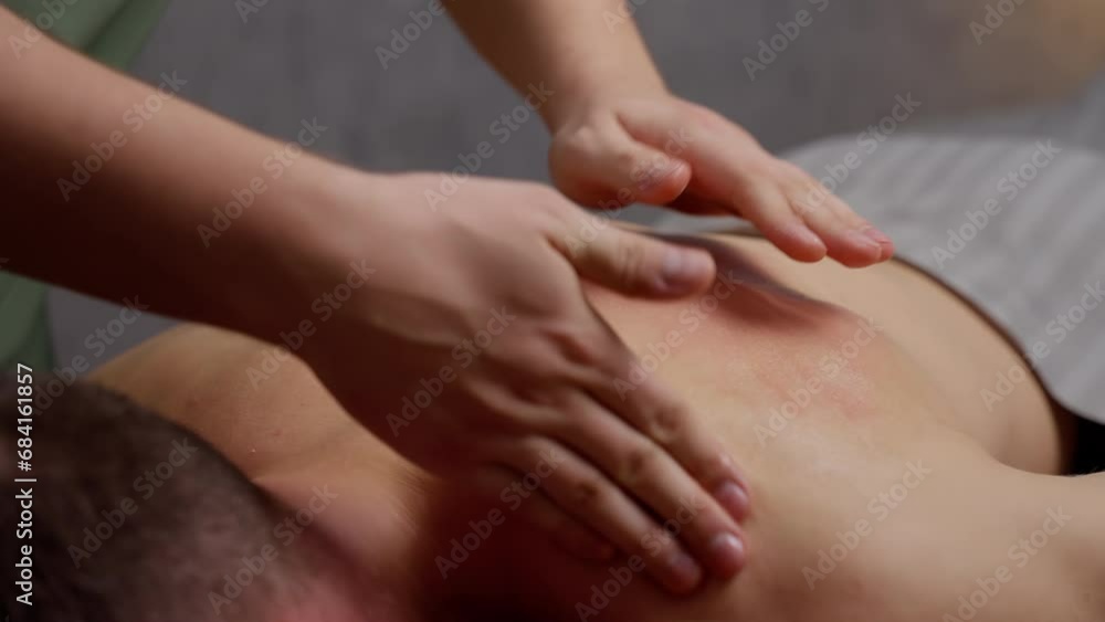 A person's skin glows under the skillful touch of a masseuse, while fingers and nails work out knots in the body and veins, soothing joints and wrists in the tranquility of an indoor massage. Slow A person's skin glows under the skillful touch of a masseuse, while fingers and nails work out knots in the body and veins, soothing joints and wrists in the tranquility of an indoor massage. Slow