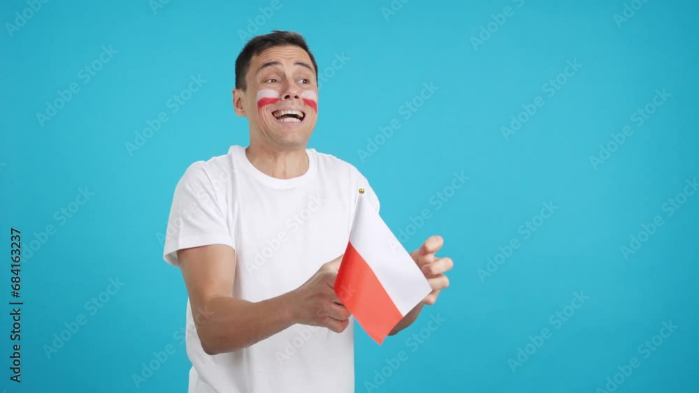 Nervous man cheering for Poland during a match looking away Nervous man cheering for Poland during a match looking away