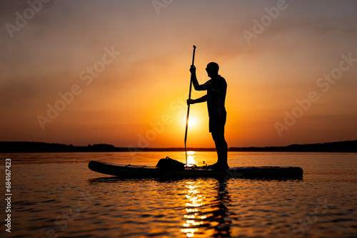 Man Enjoying Serene Water Views from a Paddle Boat on a Sunny Day