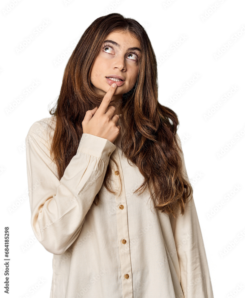 Young Caucasian woman in studio setting looking sideways with doubtful and skeptical expression. Young Caucasian woman in studio setting looking sideways with doubtful and skeptical expression.