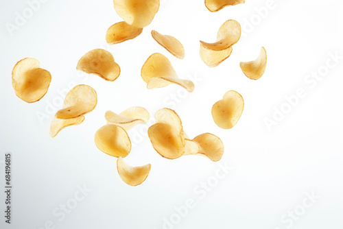 Round potato chips with spices fall in pile on light gray gradient background. Creative concept of floating snacks. Background of falling levitating potato chips. Close-up. Copy space.