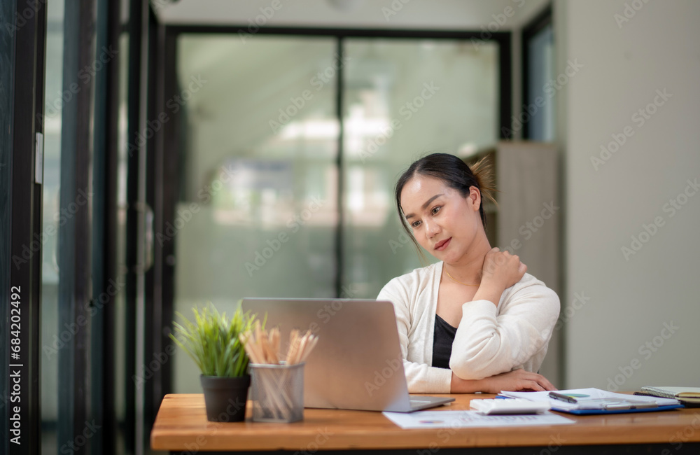 Businesswoman stretching lazy at the desk to relax while working in the office. Feeling stressed and achy from work. Businesswoman stretching lazy at the desk to relax while working in the office. Feeling stressed and achy from work.