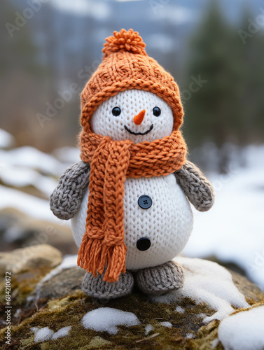 Adorable hand made toy snowman on the snow in knitted clothes isolated on white background 