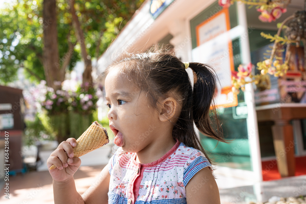 Happy asian preschool girl enjoying eat icecream travel in summer city Happy asian preschool girl enjoying eat icecream travel in summer city