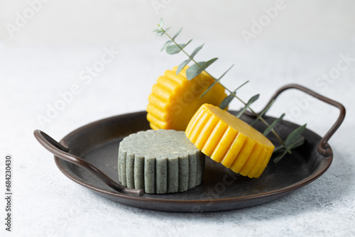 Tablou pe pânză Solid handmade bright green and yellow shampoo bars on light background close-up