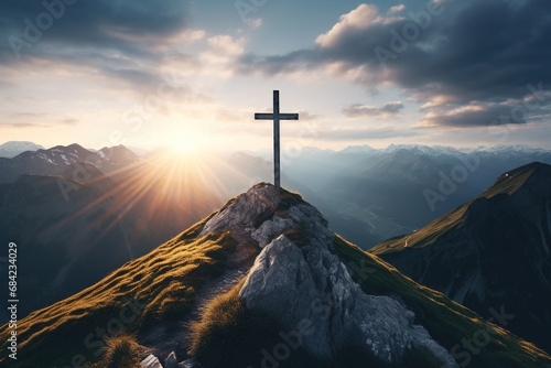 Wooden cross on the top of the mountain with clouds on the background