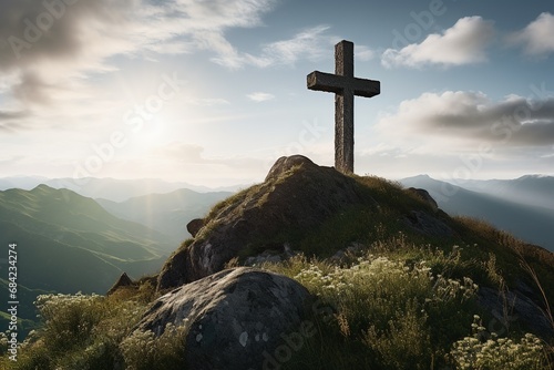Wooden cross on the top of the mountain with clouds on the background