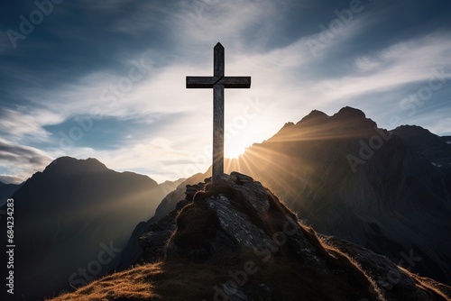 Wooden cross on the top of the mountain with clouds on the background