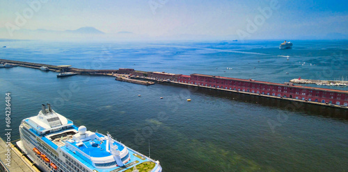 NAPLES, ITALY - JUNE 18, 2021: Aerial view of city port from a drone going up in the sky.