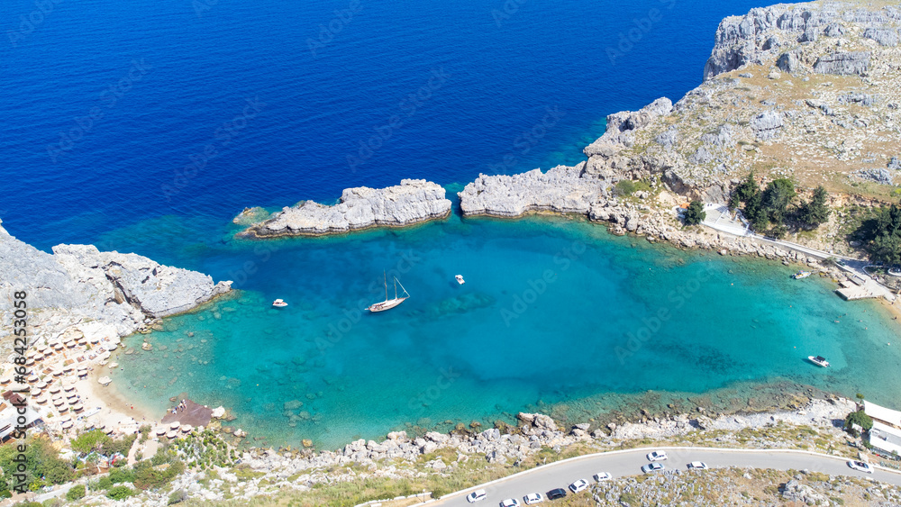 The Acropolis of Lindos in Rhodes island Greece. Saint Paul's Beach and Lindos Acropolis aerial panoramic view.