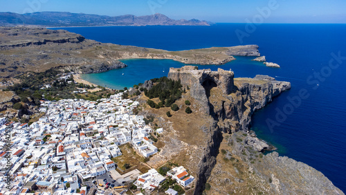 The Acropolis of Lindos in Rhodes island Greece. Saint Paul's Beach and Lindos Acropolis aerial panoramic view.